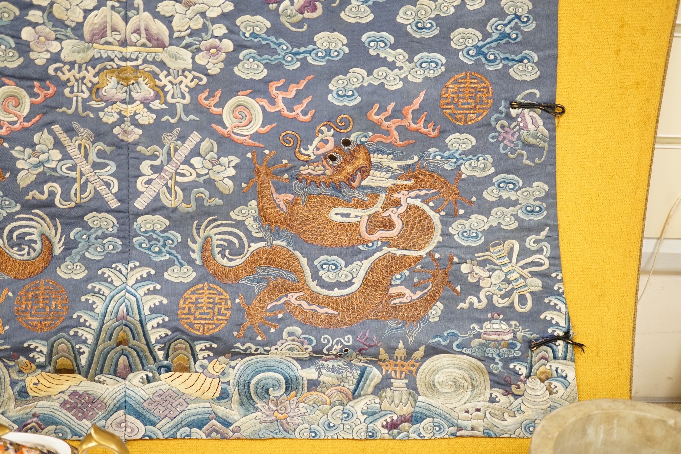 An early 20th century Chinese silk embroidered panel, from a robe, embroidered in metallic and coloured threads as dragons and auspicious symbols